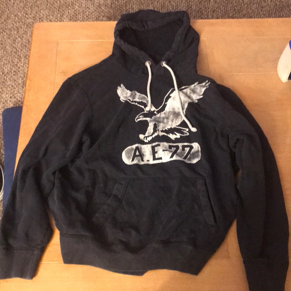 Dark blue sweatshirt with hoodie and American eagle logo.